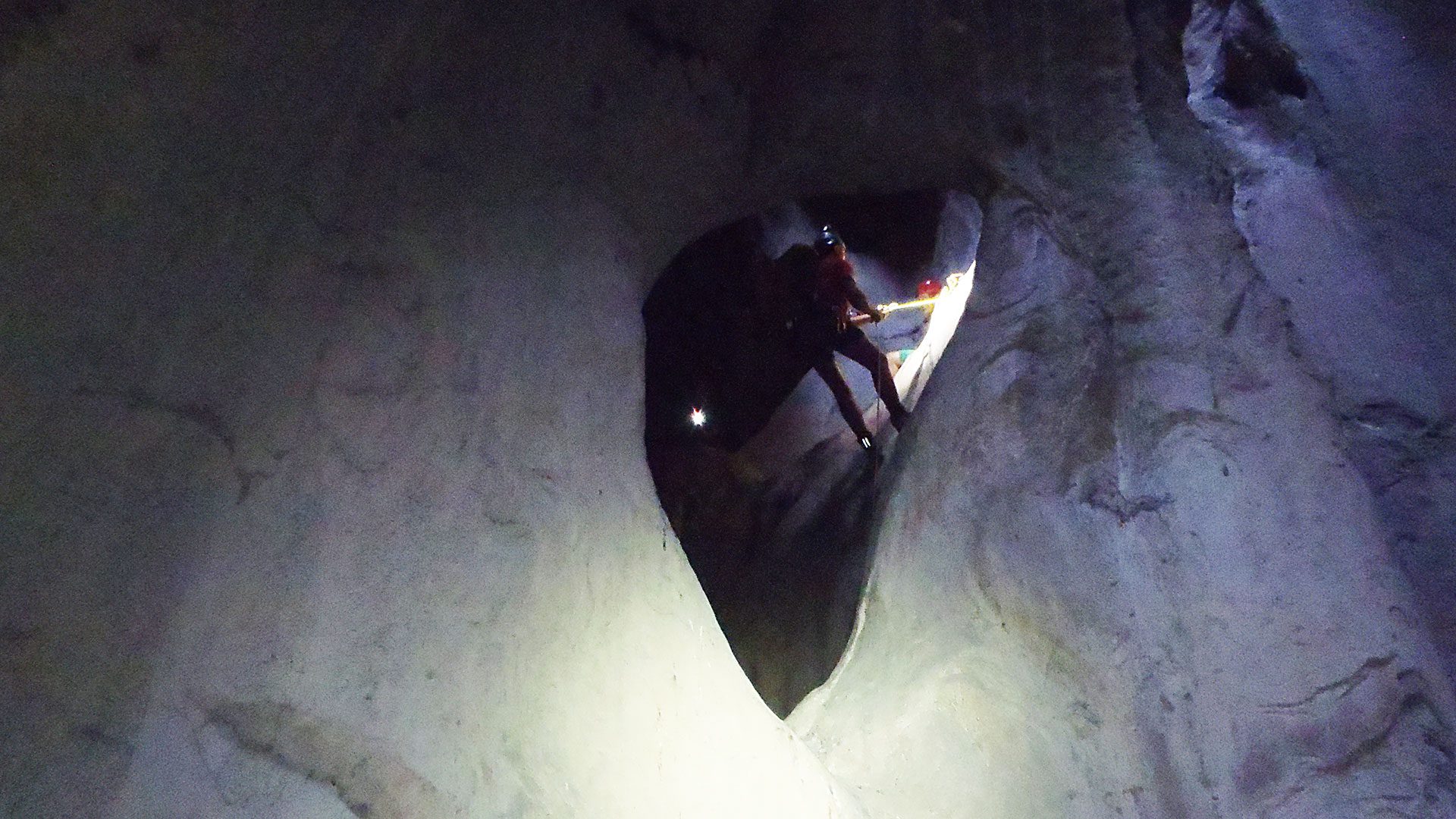 A canyoner descending in a cave