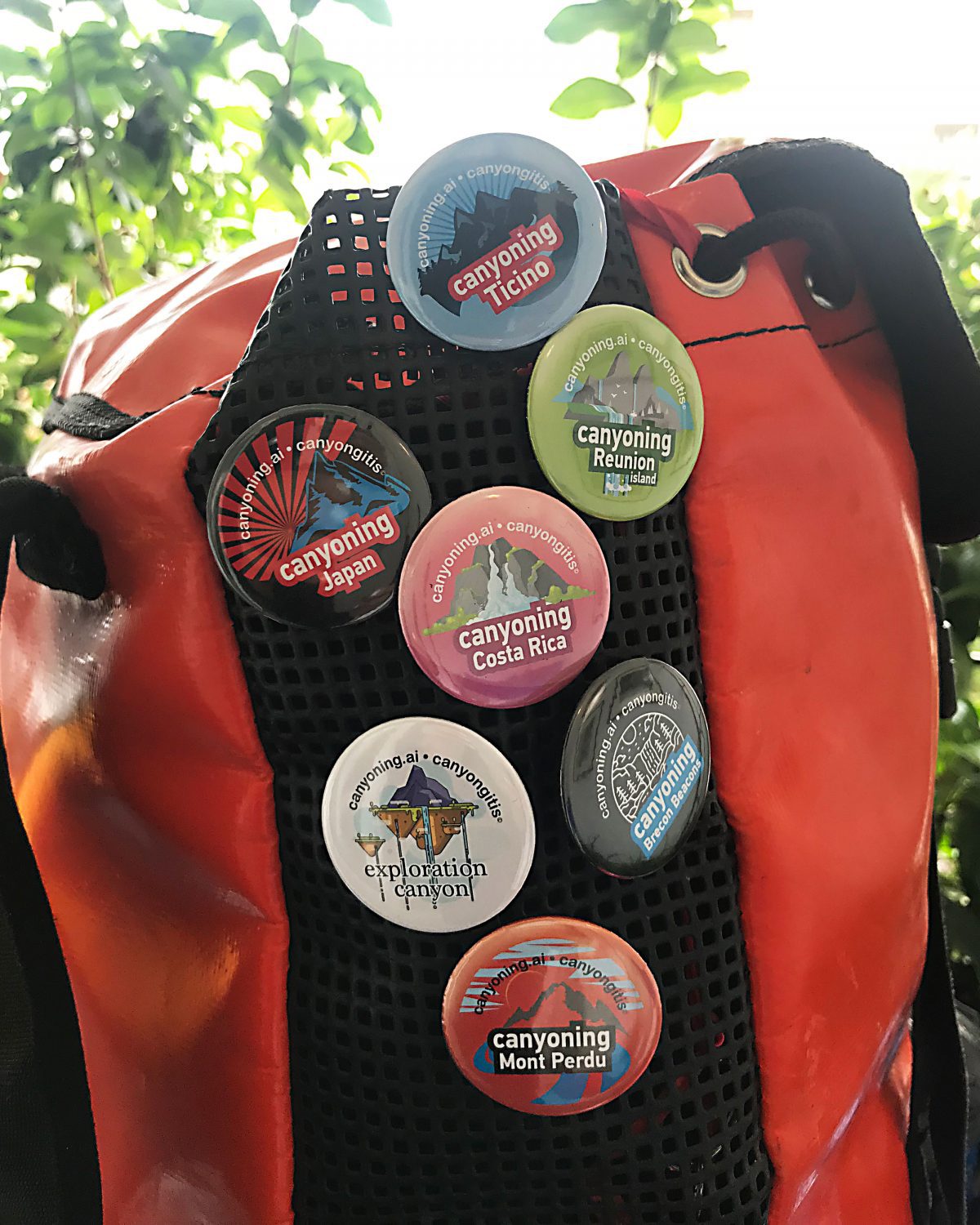 Canyongitis canyoning badges pinned on a canyoning backpack