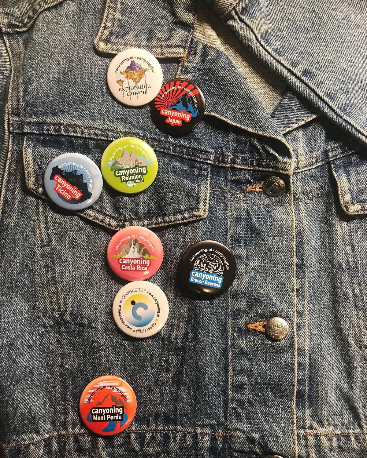 Canyoning badges pinned on a jean jacket