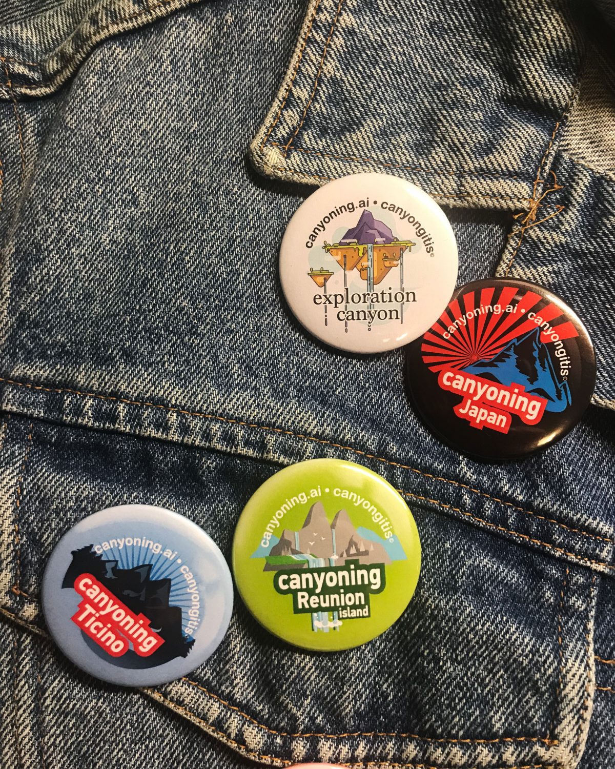 Canyoning badges pinned on a jean jacket close-up