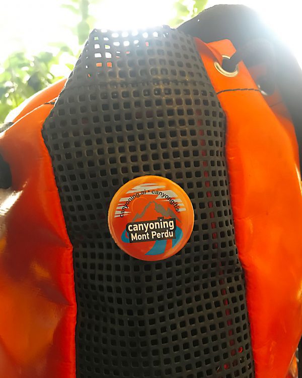 Canyoning Mont Perdu badge pinned on a canyoning backpack
