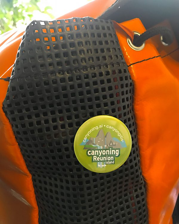 Canyoning Reunion Island badge pinned on a canyoning backpack