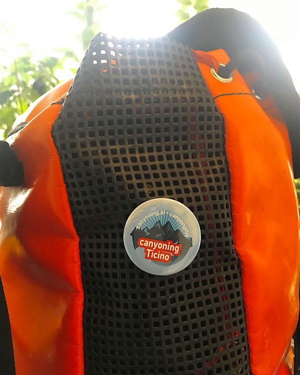 Canyoning Ticino badge pinned on a canyoning backpack