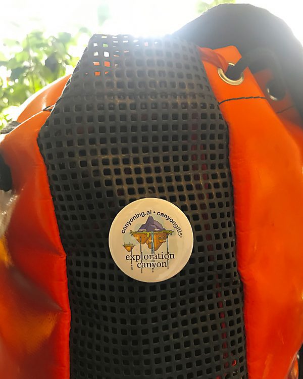 Exploration canyon badge pinned on a canyoning backpack