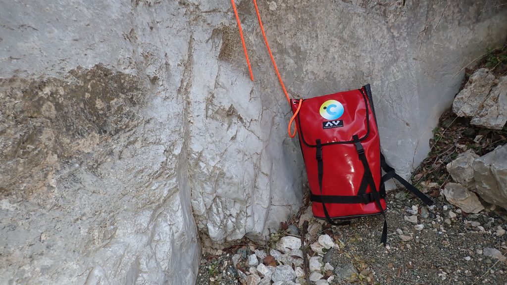 A canyoning backpack in a dry canyon